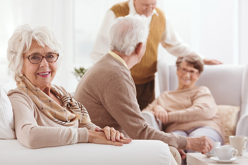 Medicare patients talking over tea in a nursing facility in Shreveport, LA