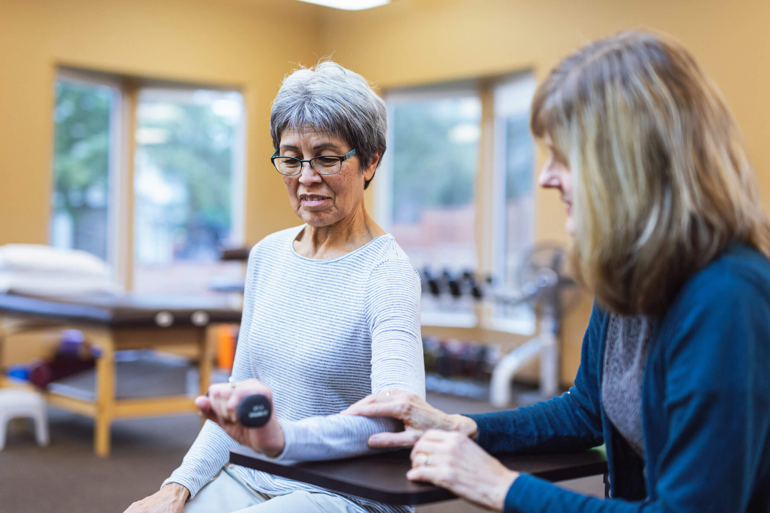 Physical therapist performs arm exam during Occupational Therapy in Shreveport, LA