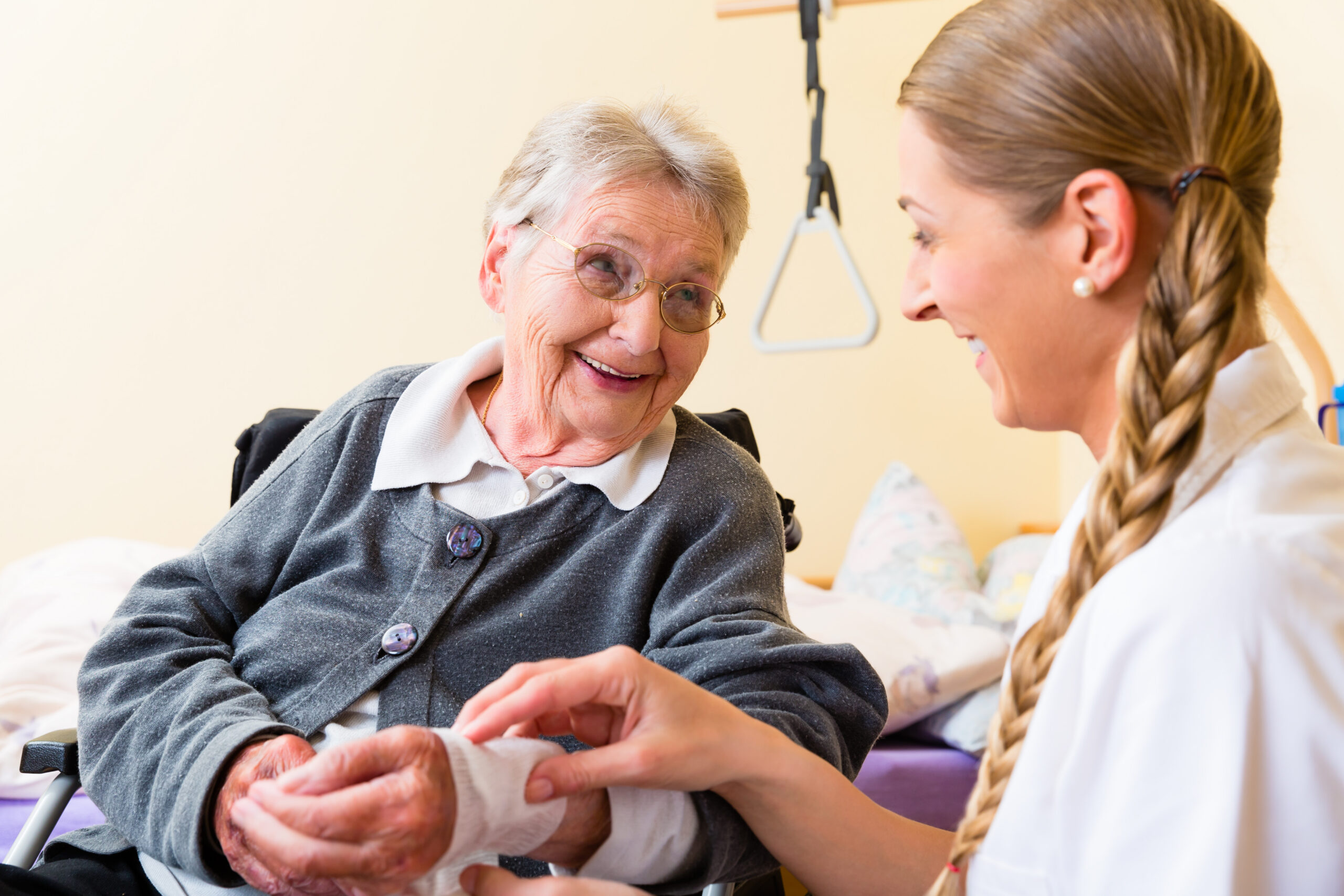 Nurse taking care of senior woman in retirement home