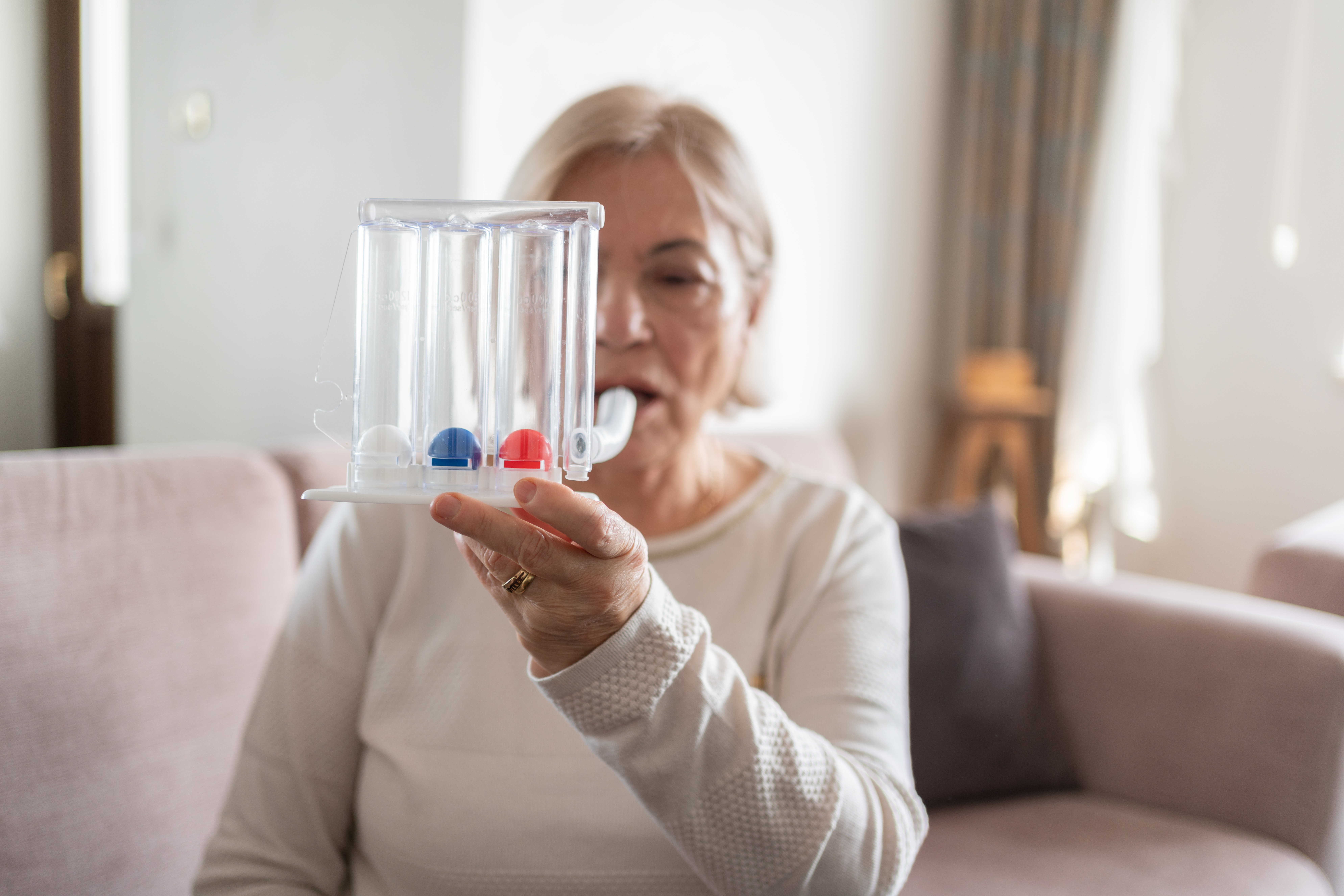 A senior doing respiratory rehabilitation