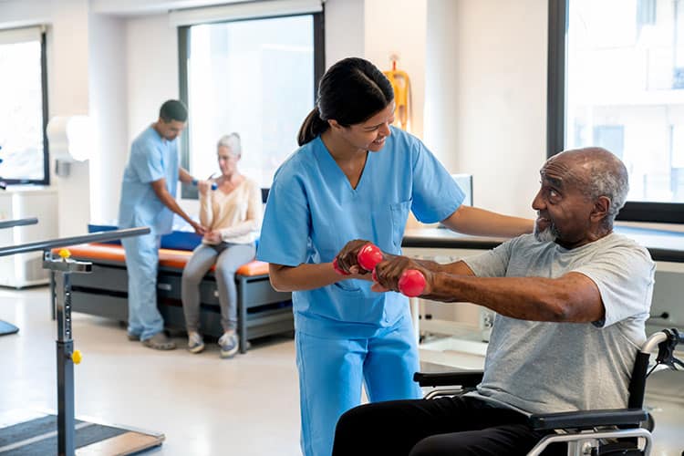 Elderly man does strength training exercises during physical therapy