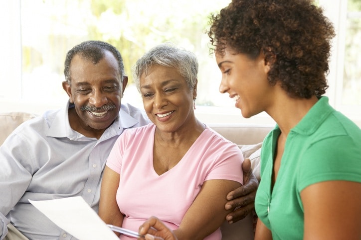 Senior couple discussing financial information with daughter