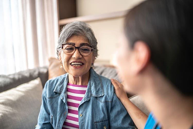 Senior woman meets with speech therapist at skilled nursing facility