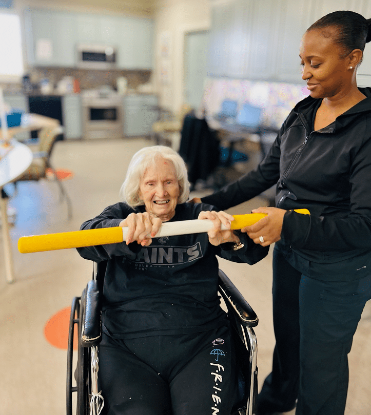 The Guest House Elderly Woman in Wheelchair in Rehab Center with Nurse