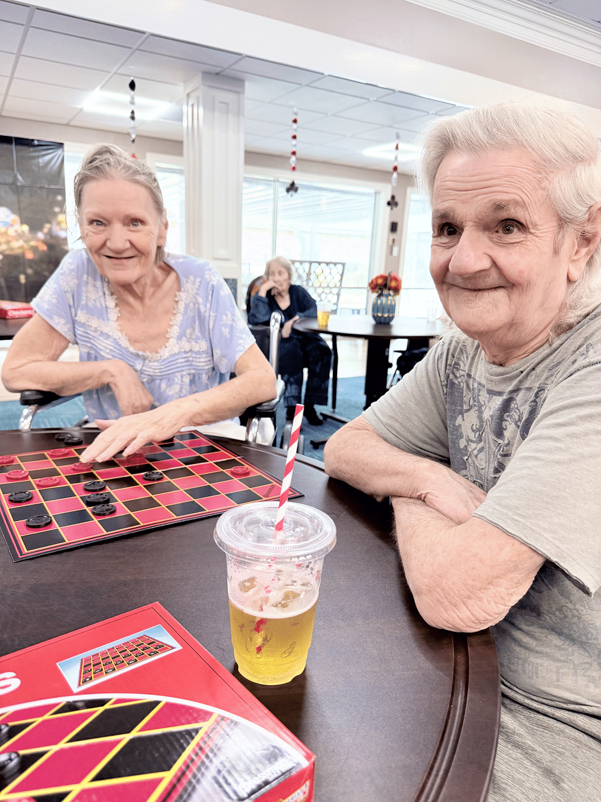 Guests enjoying a game of checkers in the common area